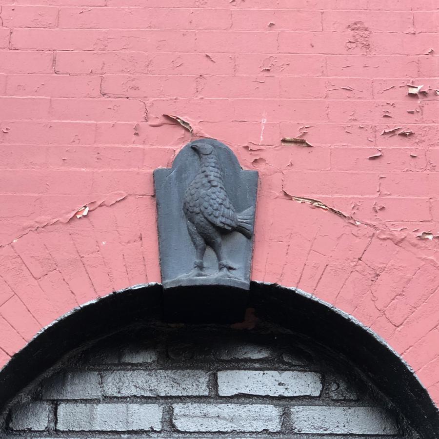 Detail photo of rooster keystone at 147 Metropolitan Avenue (former Engine Company 1)